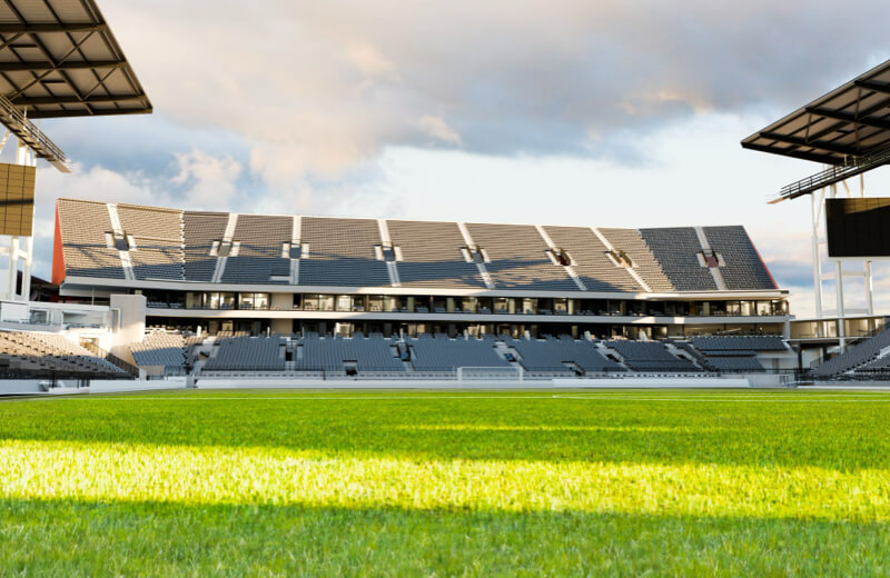 Rendering of North End and Patio from pitch of Toronto Stadium with green grass under a cloudy sky